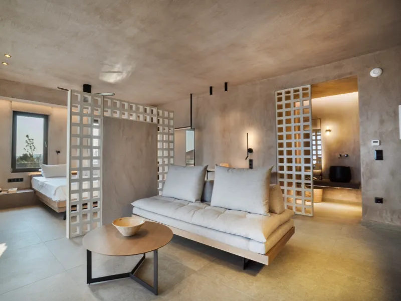 Suite living area with panoramic sea view through floor-to-ceiling windows